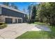 Large two-car garage with dark doors and stone accents complementing the home's exterior design at 11630 Mountain Laurel Dr, Roswell, GA 30075