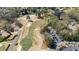 Picturesque aerial view of a lush golf course winding through a residential neighborhood with mature trees at 11630 Mountain Laurel Dr, Roswell, GA 30075