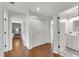 Bright hallway featuring wood floors, ample closet space, and access to a bathroom and bedroom at 11630 Mountain Laurel Dr, Roswell, GA 30075