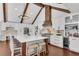 Gorgeous kitchen with large center island, breakfast bar, pendant lighting, and white cabinetry at 11630 Mountain Laurel Dr, Roswell, GA 30075