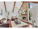Open-concept living room with a soaring ceiling, stone fireplace, hardwood floors, and ample natural light at 11630 Mountain Laurel Dr, Roswell, GA 30075