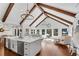Open floor plan showcasing the kitchen and living room, featuring hardwood floors, vaulted ceilings, and modern decor at 11630 Mountain Laurel Dr, Roswell, GA 30075