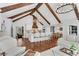 Open concept living space with kitchen, dining, and sitting areas, wood beams, white finishes, and modern decor at 11630 Mountain Laurel Dr, Roswell, GA 30075