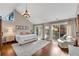 Spacious main bedroom with vaulted ceilings, wood floors, and sliding glass doors to the backyard at 11630 Mountain Laurel Dr, Roswell, GA 30075