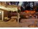 Charming outdoor patio with string lights, swing, grill, and seating area, perfect for entertaining at 11630 Mountain Laurel Dr, Roswell, GA 30075