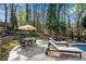 Lounge by the pool on this spacious stone deck, perfect for relaxation and outdoor gatherings at 11630 Mountain Laurel Dr, Roswell, GA 30075