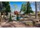 A backyard view features a sparkling pool surrounded by lush landscaping and a stone patio at 11630 Mountain Laurel Dr, Roswell, GA 30075