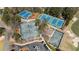 Aerial view of multiple well-maintained tennis courts surrounded by lush greenery and parking area at 11630 Mountain Laurel Dr, Roswell, GA 30075