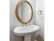 Pedestal sink with gold framed mirror in the bathroom at 3317 Regent Sw Pl, Atlanta, GA 30311