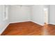 A bedroom features hardwood floors, a bathroom, and a large window at 3317 Regent Sw Pl, Atlanta, GA 30311