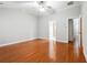 Spacious bedroom featuring hardwood floors, a ceiling fan, and an ensuite bathroom at 3317 Regent Sw Pl, Atlanta, GA 30311