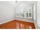Bedroom featuring hardwood floors, a vaulted ceiling and shuttered windows with views of greenery at 3317 Regent Sw Pl, Atlanta, GA 30311