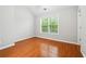 Bright bedroom with hardwood floors and a large window with wooded view at 3317 Regent Sw Pl, Atlanta, GA 30311
