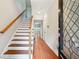 Bright hallway with hardwood floors leads to stairs and a view into another living area at 3317 Regent Sw Pl, Atlanta, GA 30311