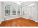 A living room filled with natural light features three large windows and hardwood floors at 3317 Regent Sw Pl, Atlanta, GA 30311