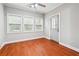 Living room features hardwood floors, a ceiling fan, and 3 large windows allowing for tons of natural light at 3317 Regent Sw Pl, Atlanta, GA 30311