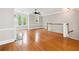 Bright open concept living room with hardwood floors, a fireplace, and large windows at 3317 Regent Sw Pl, Atlanta, GA 30311