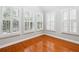 Sunlit room with hardwood floors and multiple shuttered windows offering exterior views at 3317 Regent Sw Pl, Atlanta, GA 30311
