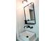Bathroom sink and lighting fixture mounted on light herringbone pattern tile wall at 403 Red Oak Ln, Lawrenceville, GA 30046