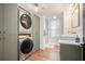 Modern bathroom includes stacked washer and dryer and tiled walk-in shower at 403 Red Oak Ln, Lawrenceville, GA 30046