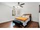 Sun-filled bedroom features a comfortable queen-sized bed with a modern ceiling fan at 403 Red Oak Ln, Lawrenceville, GA 30046