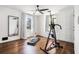 Bedroom with hardwood floors, large windows, ceiling fan, and built-in storage at 403 Red Oak Ln, Lawrenceville, GA 30046