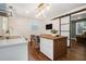 Bright eat-in kitchen features an island with seating and views into the living room at 403 Red Oak Ln, Lawrenceville, GA 30046