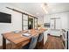 Eat-in kitchen featuring a rustic wood dining table and modern stainless steel appliances at 403 Red Oak Ln, Lawrenceville, GA 30046