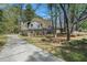 Charming two-story home featuring a brick foundation, vinyl siding, and a long driveway at 403 Red Oak Ln, Lawrenceville, GA 30046