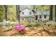 Charming exterior view of the house surrounded by lush landscaping and mature trees at 403 Red Oak Ln, Lawrenceville, GA 30046