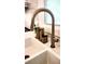 Close-up of a kitchen sink with a modern bronze faucet and white countertops at 403 Red Oak Ln, Lawrenceville, GA 30046