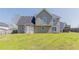 Large backyard featuring a spacious lawn and home's exterior, perfect for outdoor enjoyment at 705 Brentwood Pkwy, Stockbridge, GA 30281