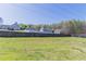 Expansive grassy backyard enclosed by a tall wooden fence, offering ample space for recreation and relaxation at 705 Brentwood Pkwy, Stockbridge, GA 30281