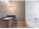 Bright bathroom featuring a single sink, granite countertops, and a large mirror at 705 Brentwood Pkwy, Stockbridge, GA 30281