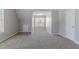 Well-lit, carpeted bonus room with ample space, suitable for various activities and functions at 705 Brentwood Pkwy, Stockbridge, GA 30281