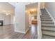 Inviting entryway featuring wood floors, carpeted stairs, and views of the living room and kitchen at 705 Brentwood Pkwy, Stockbridge, GA 30281