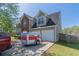 Side view of a home with a two-car garage, a trailer, and a partial view of the brick facade at 705 Brentwood Pkwy, Stockbridge, GA 30281