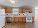 Well-lit kitchen equipped with ample wood cabinets, stainless steel appliances, and tile backsplash at 705 Brentwood Pkwy, Stockbridge, GA 30281