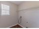 Functional laundry area with a window and storage shelf, providing a practical space for chores at 705 Brentwood Pkwy, Stockbridge, GA 30281