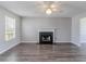 Inviting living room featuring a decorative fireplace, ceiling fan, and wood-look flooring at 705 Brentwood Pkwy, Stockbridge, GA 30281