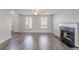 Spacious living room with a decorative fireplace, large windows, and attractive wood-look floors at 705 Brentwood Pkwy, Stockbridge, GA 30281