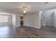 Open-concept living area with hardwood-style floors, a fireplace, and access to the kitchen and entryway at 705 Brentwood Pkwy, Stockbridge, GA 30281