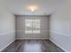 Bright living room with wood floors, neutral walls, and a large window offering natural light at 705 Brentwood Pkwy, Stockbridge, GA 30281