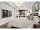 Bright primary bedroom featuring crown molding, large bed with stylish pillows and decor art at 850 Piedmont Ne Ave # 1206, Atlanta, GA 30308
