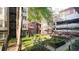 Courtyard view showcasing manicured landscaping and multi-story brick building at 850 Piedmont Ne Ave # 1206, Atlanta, GA 30308