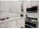 Well-lit kitchen features stainless steel appliances, white cabinets, and sleek countertops at 850 Piedmont Ne Ave # 1206, Atlanta, GA 30308