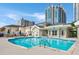Community pool with tiled edge surrounded by lounge-chair seating areas and landscaping at 850 Piedmont Ne Ave # 1206, Atlanta, GA 30308