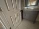 A partially visible bathroom vanity with marble top and grey cabinets at 1315 Old Coach Sw Rd, Marietta, GA 30008