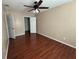 A cozy bedroom featuring hardwood floors and a ceiling fan with integrated lighting at 1315 Old Coach Sw Rd, Marietta, GA 30008