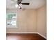 Bedroom featuring hardwood floors, a ceiling fan, and a window providing natural light at 1315 Old Coach Sw Rd, Marietta, GA 30008